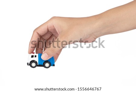 Hand holding Ambulance Toy isolated on a white background.