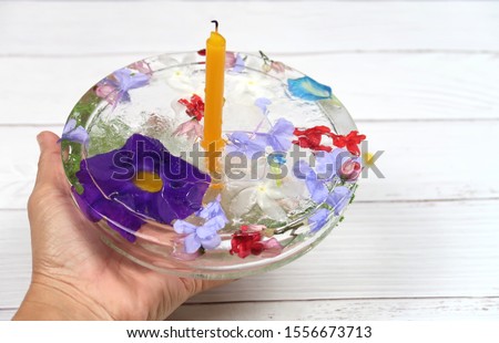 Krathong which made of water freezing in concept of save the environment and decorated with flowers is meaning lotus for respecting the river in Loy Krathong Festival in Thailand.