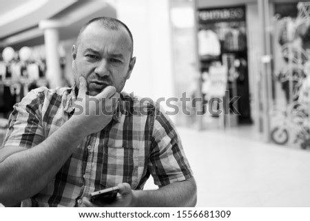 portrait of a man in a cafe at a table, black and white photo