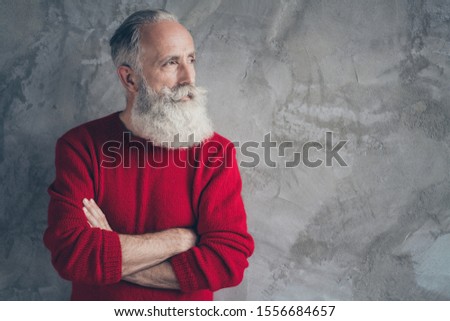Photo of nice aged guy holding hands crossed looking empty space minded wear red knitted pullover jumper cool hipster santa outfit isolated grey color wall background