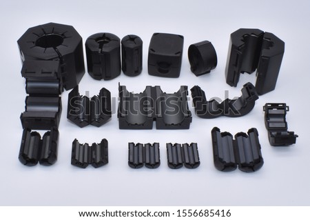Ferrite for EMI suppression. Round Ferrite Clamp perfect for test and measuring purposes in EMC test labs. Ferrite chokes for emission test. Fastening Pre-fixing for round cables. Clamping protection. Royalty-Free Stock Photo #1556685416