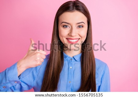 Photo of amazing lady raising thumb up approving good quality of product wear blue dotted shirt with collar isolated pink color background