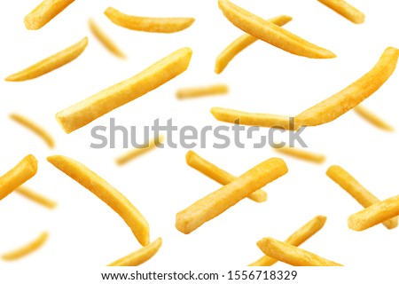 Falling french fries, potato fry isolated on white background, selective focus Royalty-Free Stock Photo #1556718329