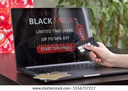 Girl makes purchases over the internet on black friday