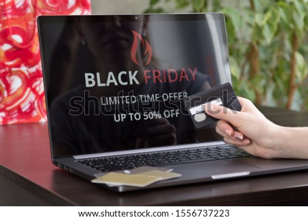 Girl makes purchases over the internet on black friday