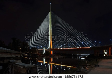 Modern suspension bridge with 200 m high pylon illuminated in dark night