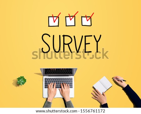 Survey with people working together with laptop and notebook