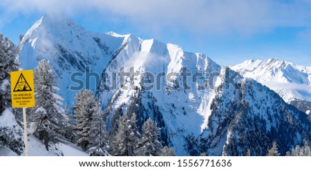 Photo of picturesque highlands with snow mountains, fir trees and blue sky