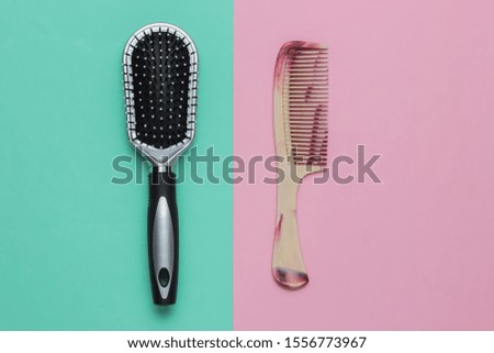 Combs on a blue-pink pastel background. Beauty minimalistic concept. Hair care. Top view