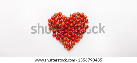 Creative vegetarian concept. Heart shaped cherry tomatoes isolated on white panoramic background, copy space