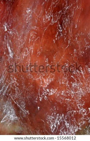 lovely abstract image of an interesting water texture against a red stone surface