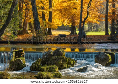 München: English Garden - beautiful colors inn autumn: waterfall & trees