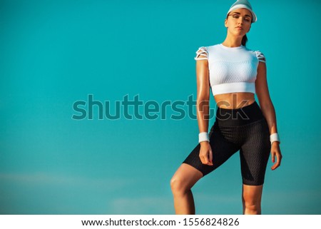 Sporty and fit young woman athlete relaxed after yoga training on the sky background. The concept of a healthy lifestyle and sport. Individual sports recreation.