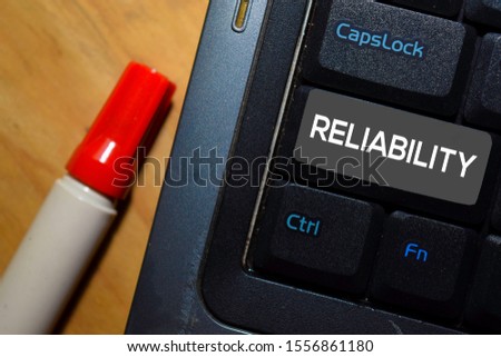 Reliability write on keyboard isolated on laptop background