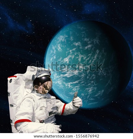 Astronaut give thumbs up against extrasolar planet. The elements of this image furnished by NASA.
