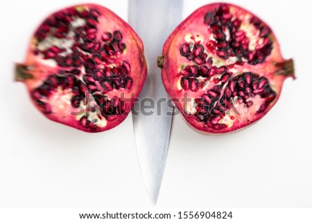 pomegranate cut in half on a white background. 