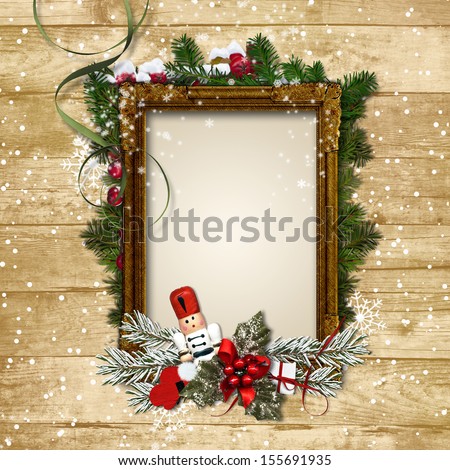 Christmas frame with the decor and the Nutcracker on a wooden ba