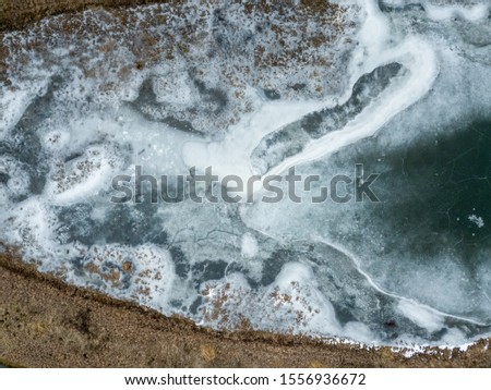 Aerial drone image of Blue frozen lake with pattern and texture