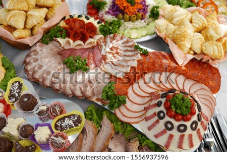 Buffet table of reception with cold snacks, meat, salads and fruits                 