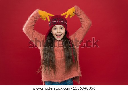 Beautiful crazy. Crazy child show horns on head. Happy girl with crazy look red background. Crazy holiday mood. Winter holidays. Fashion and accessory for kids.