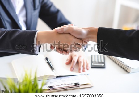 Realtors are making a handshake agreement. The success of the agreement. Property
