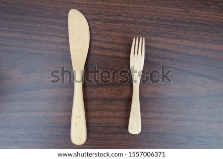 
Wooden butter knife and dessert fork on the table.