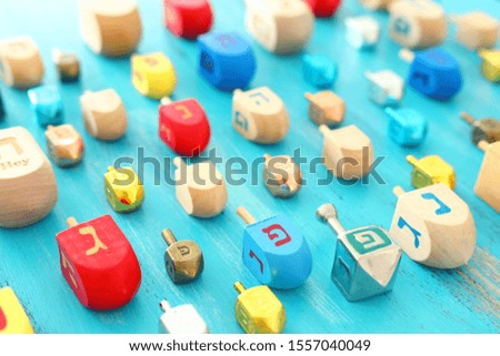religion concept of jewish holiday Hanukkah with dreidels colection (spinning top) over blue background