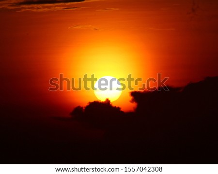 Gorgeous panorama scenic of the strong sunrise with silver lining and cloud on the orange sky