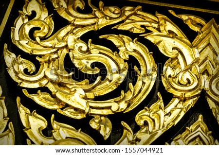 Closeup Thai pattern carving Kanok picture in temple
