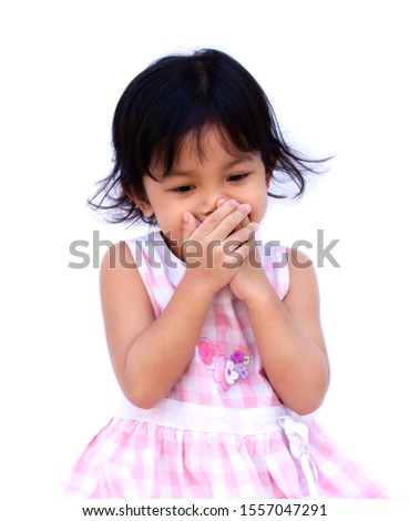 Little girl  She uses her hand to cover her mouth. isolated on white background