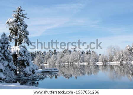 lake and reflection in snowy forest.