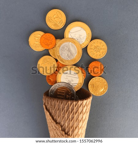 Sweet background. Waffle cone and chocolate coins. Pirate treasures.