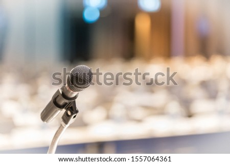 Close up of microphone on a podium in an auditorium with bokeh background