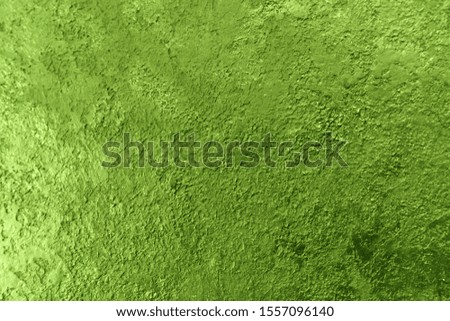 
Background texture of a textured wall in green. Stylized textural banner with space for text.
