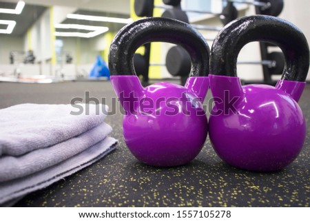 two kettlebells and a towel on the floor in the gym, the concept of sports and exercise
