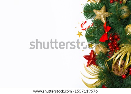 Christmas frame of spruce branches, red berries and decorations in red and gold. Christmas wallpaper. top view, copy space