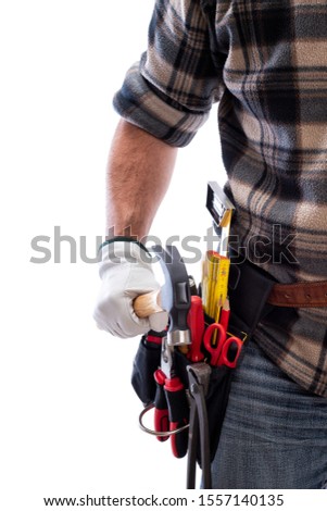 Carpenter isolated on a white background, he wears leather work gloves. He is holding the hammer. Work tools industry construction and do it yourself housework. Stock photography.