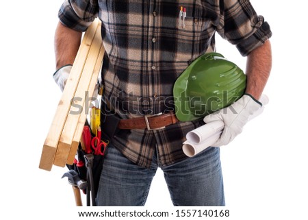 Carpenter isolated on a white background, he wears leather work gloves. He is holding wooden boards, the helmet and the work project. Work tools industry construction and do it yourself housework. 