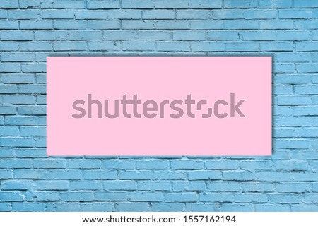 Pastel pink paper sheet on Light blue brick wall background. Top view. Place for text. Texture of a brick wall. Template or mock up.