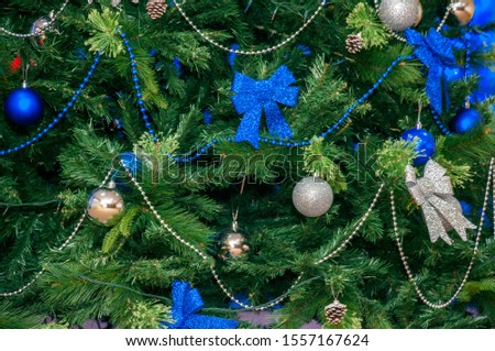 Decorated Christmas tree in blue-green tones close-up part
