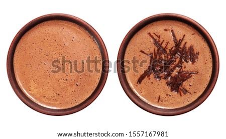 Two cups of hot chocolate or cocoa drink isolated on white, top view