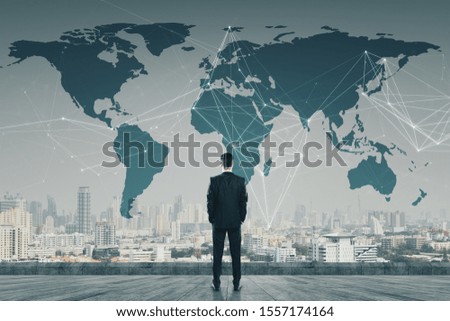 Businessman standing on roof with digital map. AI and global concept Royalty-Free Stock Photo #1557174164
