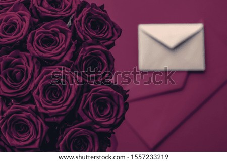 Holidays gift, floral present and happy relationship concept - Love letter and flowers delivery on Valentines Day, luxury bouquet of roses and card on wine background for romantic holiday design