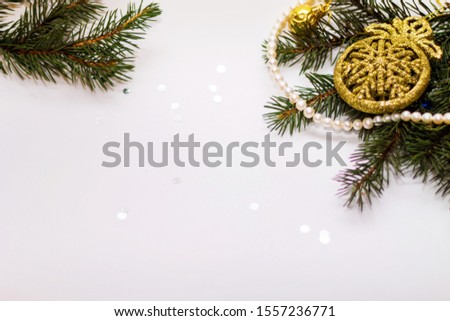Green fir branches with decorations in the corner closeup on white background, New year, Christmas