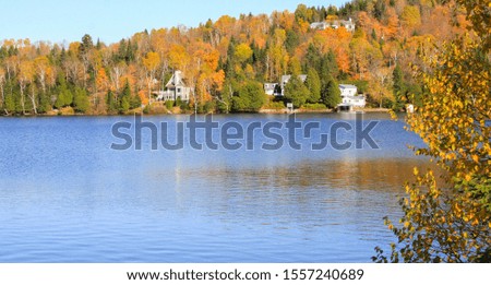 Autumn over the Tremblant Lake, As flamboyant colours of fall quietly take over the mountain