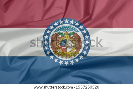 Fabric flag of Missouri. Crease of Missouri flag background, the states of America, red white and blue color. The Missouri Seal, surrounded by a blue band and stars.
