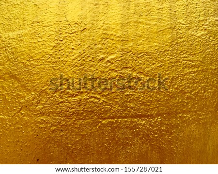 Gold cement wall background for texture abstract