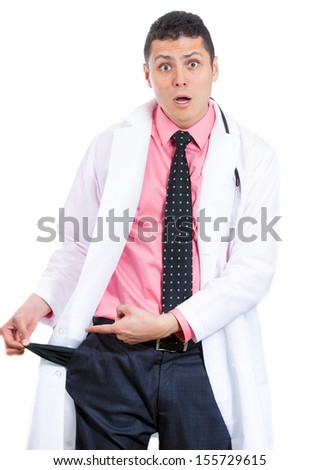 Closeup portrait of healthcare professional or doctor or nurse or dentist, pulling out empty pocket showing he is broke and poor isolated on white background. Health care reform. Obamacare debate.