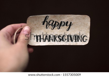 The inscription "Happy Thanksgiving" in the hand