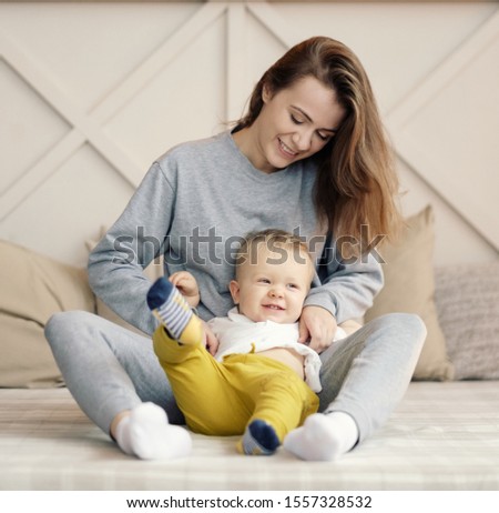 mother and child on bed, funny happy mother and son